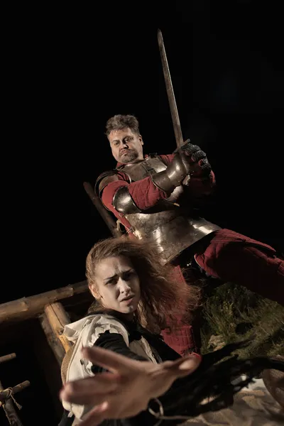 Medieval knight is going to make an execution of a witch — Stock Photo, Image