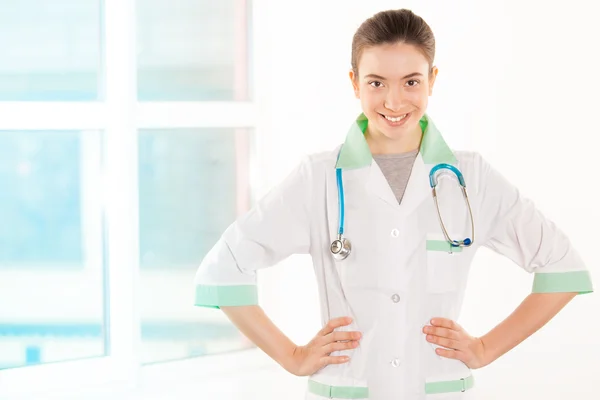 Young doctor in white and green coat — Stock Photo, Image