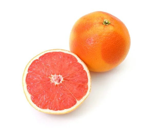 Polovina a celé grapefruitů — Stock fotografie