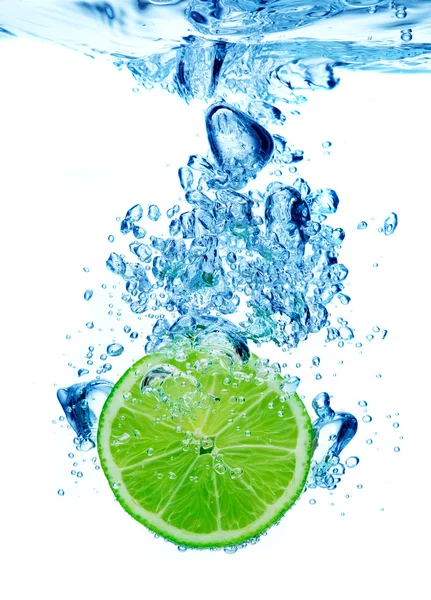 Lime in spray of water — Stock Photo, Image