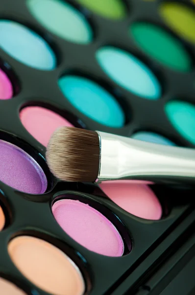 Multicolored eye shadows with cosmetics brush — Stock Photo, Image