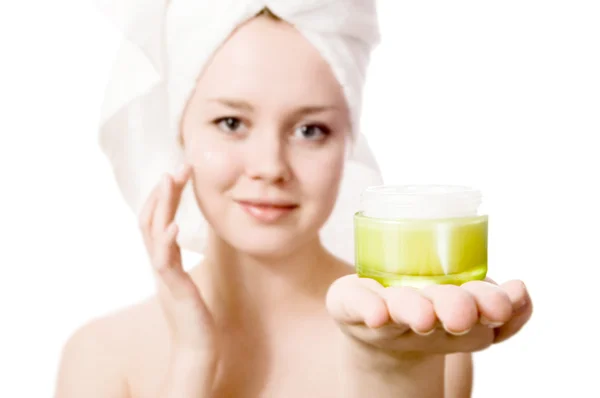 Young girl with towel on her head and cream. — Stock Photo, Image