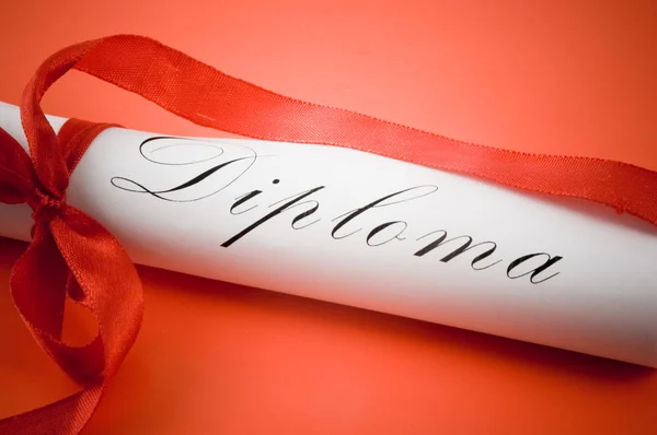 Diploma with red ribbon on red background — Stock Photo, Image