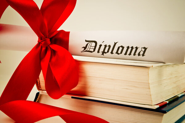 Diploma with red ribbon and books