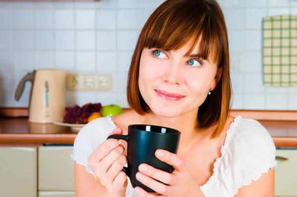 Young woman, enjoying a cup of coffee in her home. Stock Image