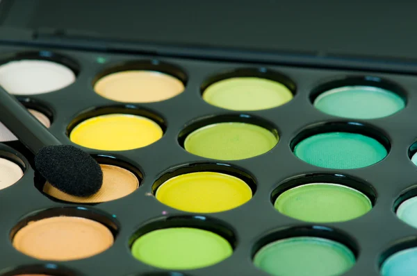 Multicolored eye shadows with cosmetics brush — Stock Photo, Image