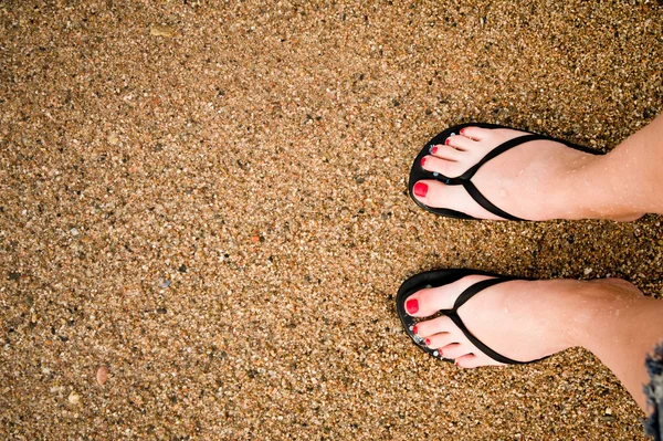 Jambes de fille mince sur la plage de sable fin — Photo