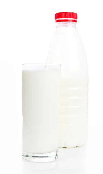 Glass of milk and bottle on white background — Stock Photo, Image