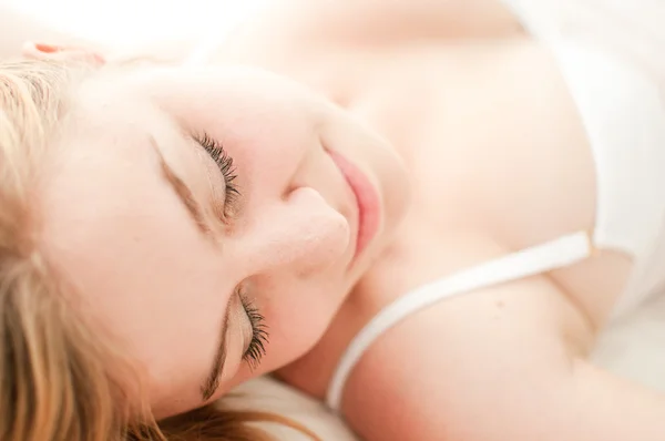 Sexy blond woman sleep on bed in lingerie — Stock Photo, Image