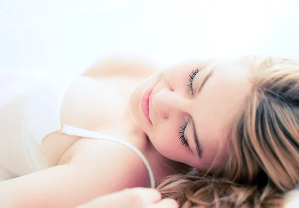 Sexy blond woman sleep on bed in lingerie — Stock Photo, Image