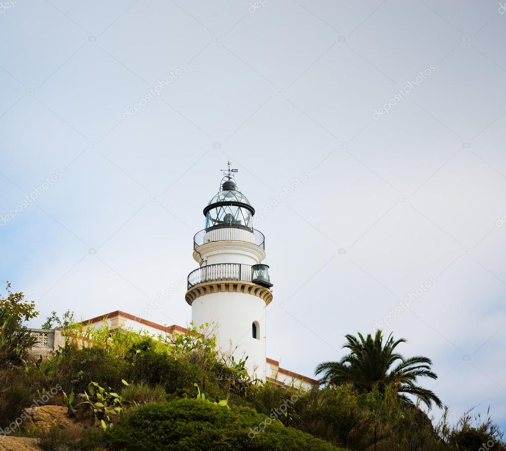 Old lighthouse on sea coast. Calella. Catalonia. Spain