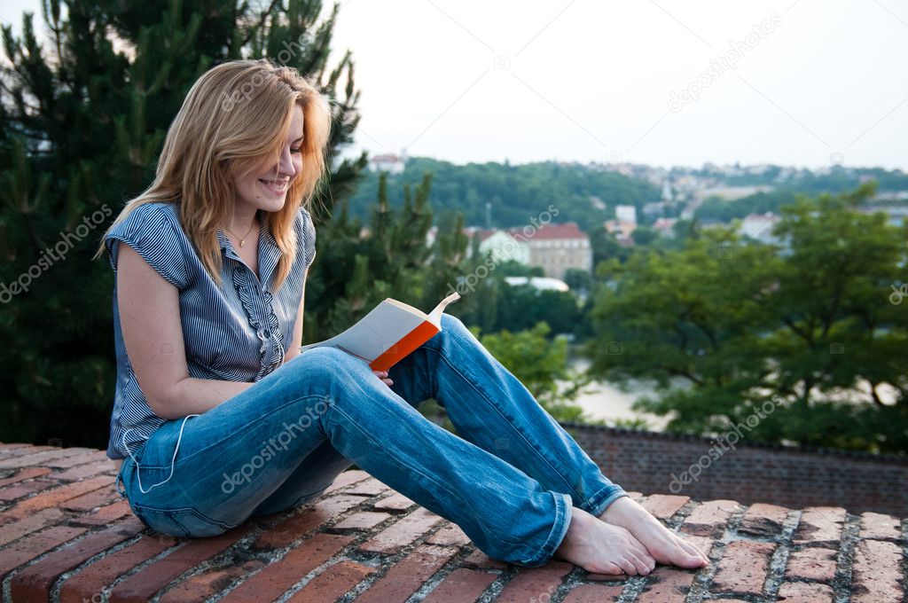 Woman sitting and reading in Prague
