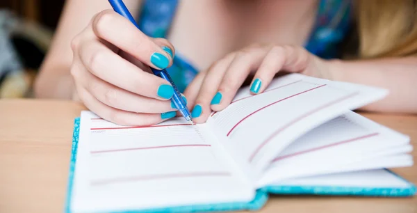 Hand of young woman taking notes — Stock Photo, Image