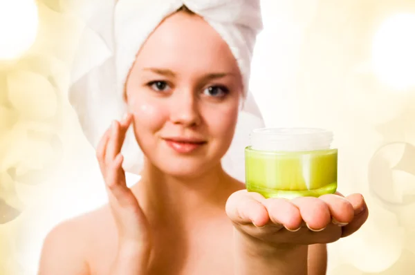 Young girl with towel on her head and cream. — Stock Photo, Image