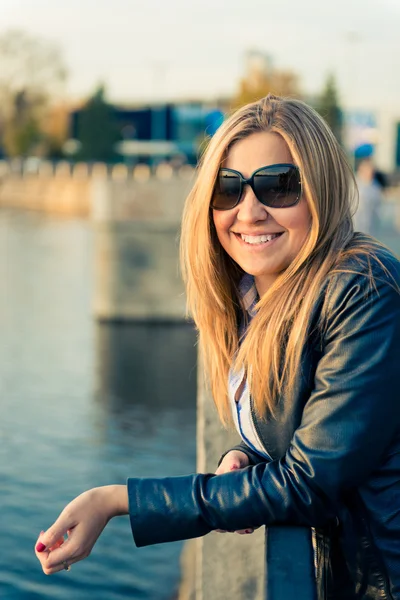 Beautiful woman near fence — Stock Photo, Image