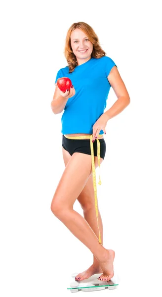 Woman with red apple crouching on scale — Stock Photo, Image