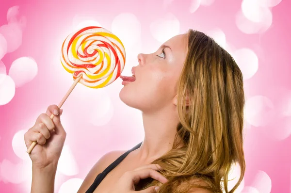 Woman licking sweet sugar candy closeup. — Stock Photo, Image