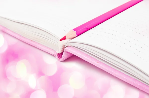 Pink notebook and pencil — Stok fotoğraf