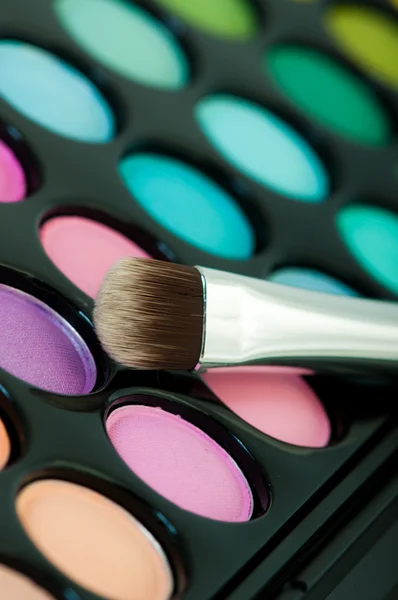 Multicolored eye shadows with cosmetics brush — Stock Photo, Image