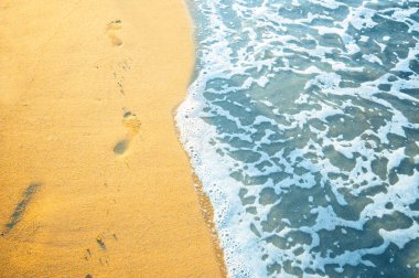 Footprint on sand with foam