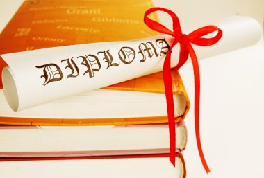 Diploma with red ribbon and books clipart