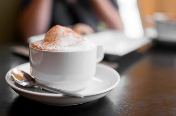 Une tasse de cappuccino avec mousse de lait et cannelle — Photo