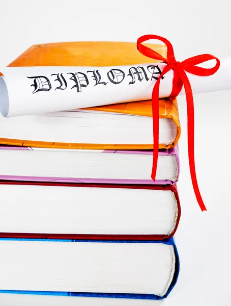 Diploma con cinta roja y libros — Foto de Stock