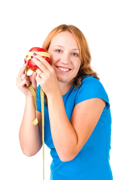 Portrait of a young sport woman holding apple and measuring tape — Stock Photo, Image