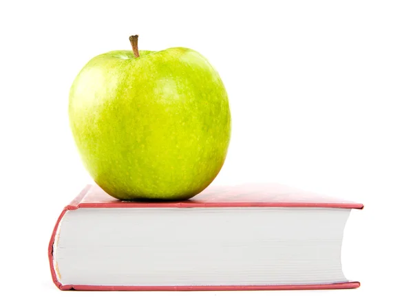 A green apple on a book — Stock Photo, Image