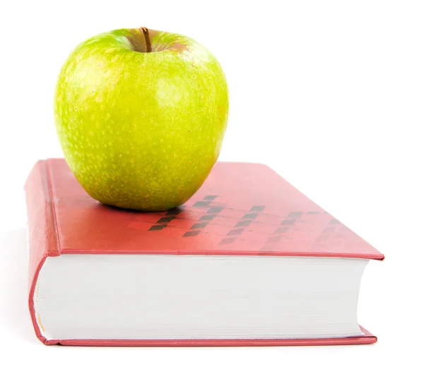 A green apple on a book — Stock Photo, Image