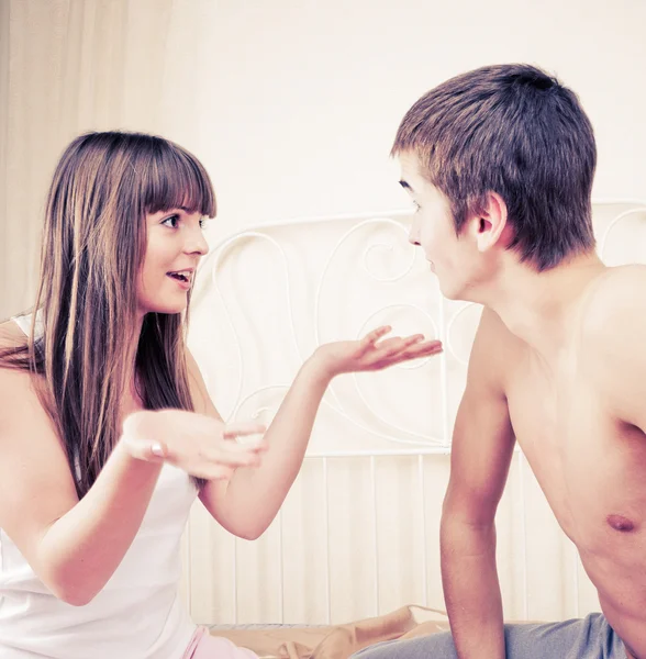 Portrait of an angry couple shouting each other against white ba — Stock Photo, Image