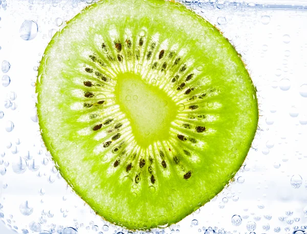 Sliced kiwi covered with bubbles — Stock Photo, Image