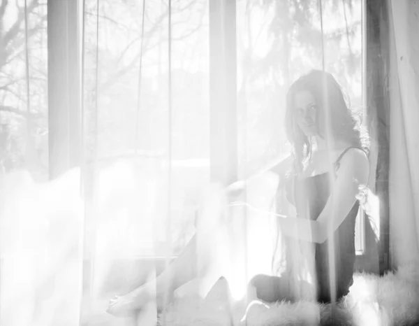 Chica sentada en alféizar de la ventana — Foto de Stock