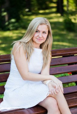 Parktaki bankta oturan genç kadın