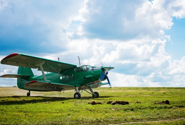 Old airplane on green grass — Stock Image Old airplane on green grass Royalty Free Stock Photos
