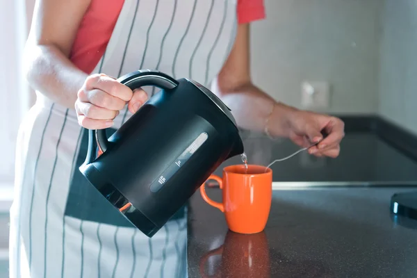 pouring hot drink to the mug