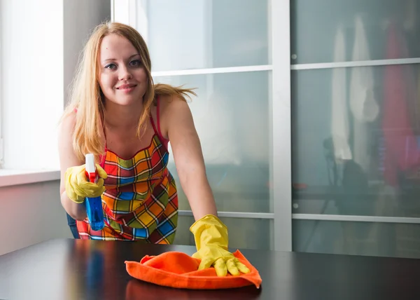 Happy girl cleaning table with furniture polish at home — Stock Photo, Image