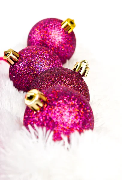 Four red Christmas ball on white fur — Stock Photo, Image