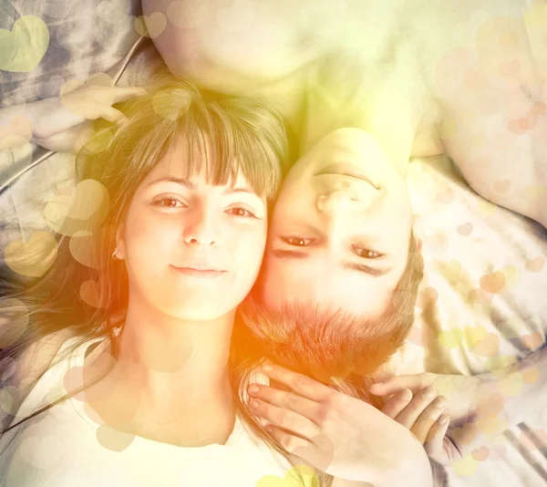 Young happy couple in bed — Stock Photo, Image