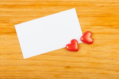 Kırmızı Kalpler ve ahşap zemin üzerine Not