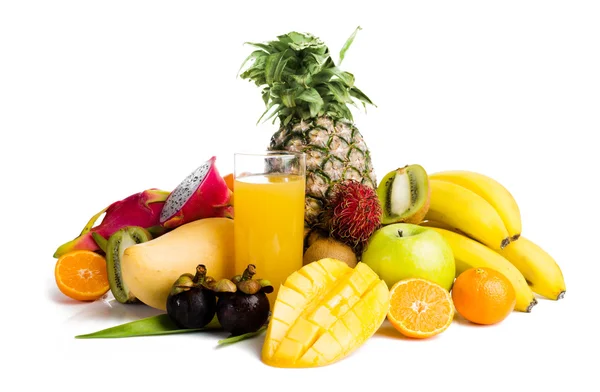 Juice in glass and tropical fruit — Stock Photo, Image