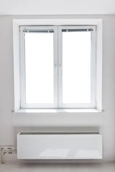 White plastic double door window with radiator under it. — Stock Photo, Image