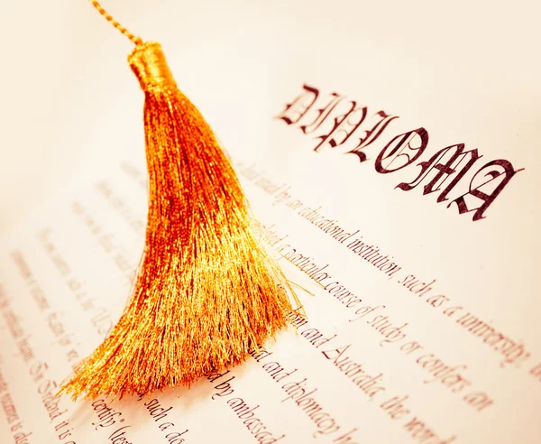 Diploma with tassel from Graduation hat — Stock Photo, Image