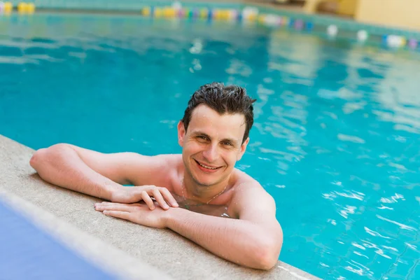 Man posing in the swimming pool — Stock Photo, Image