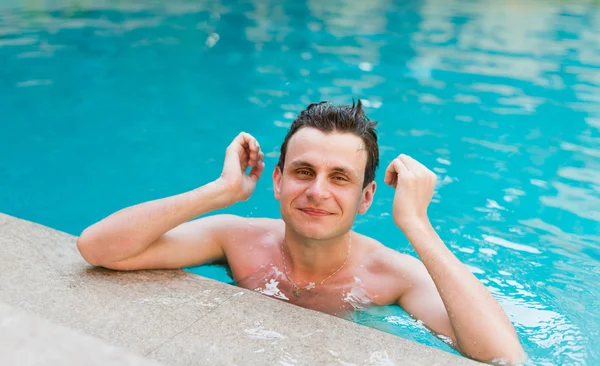 Man posing in the swimming pool — Stock Photo, Image