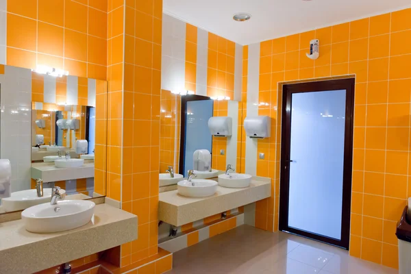 Общественный пустой туалет с зеркалом для умывальников — стоковое фото