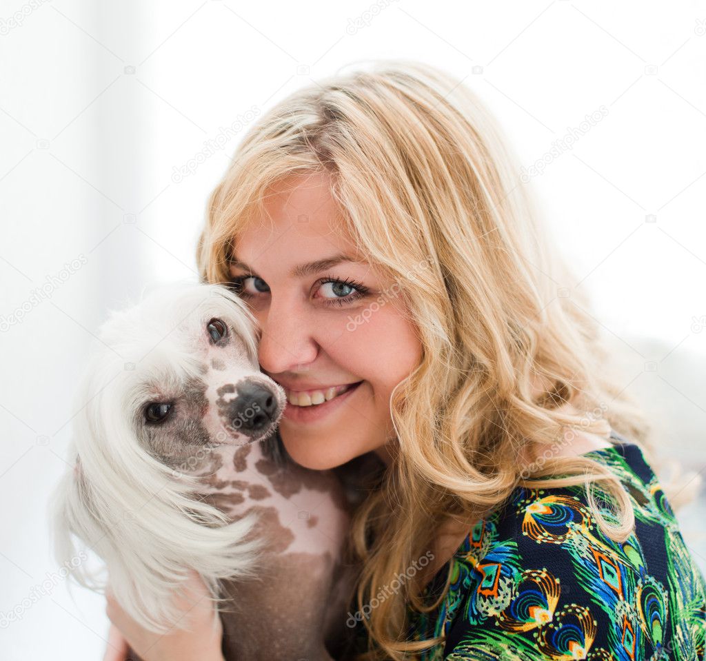 Woman keeping Chinese crested dog