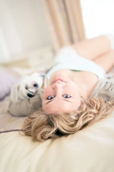 Young woman is holding a dog — Stock Photo, Image