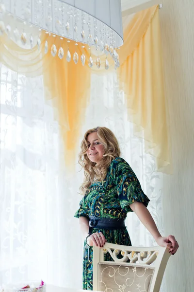 Young girl near window — Stock Photo, Image