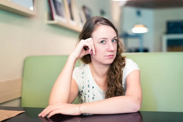 Beautiful brunette in cafe — Stock Photo, Image